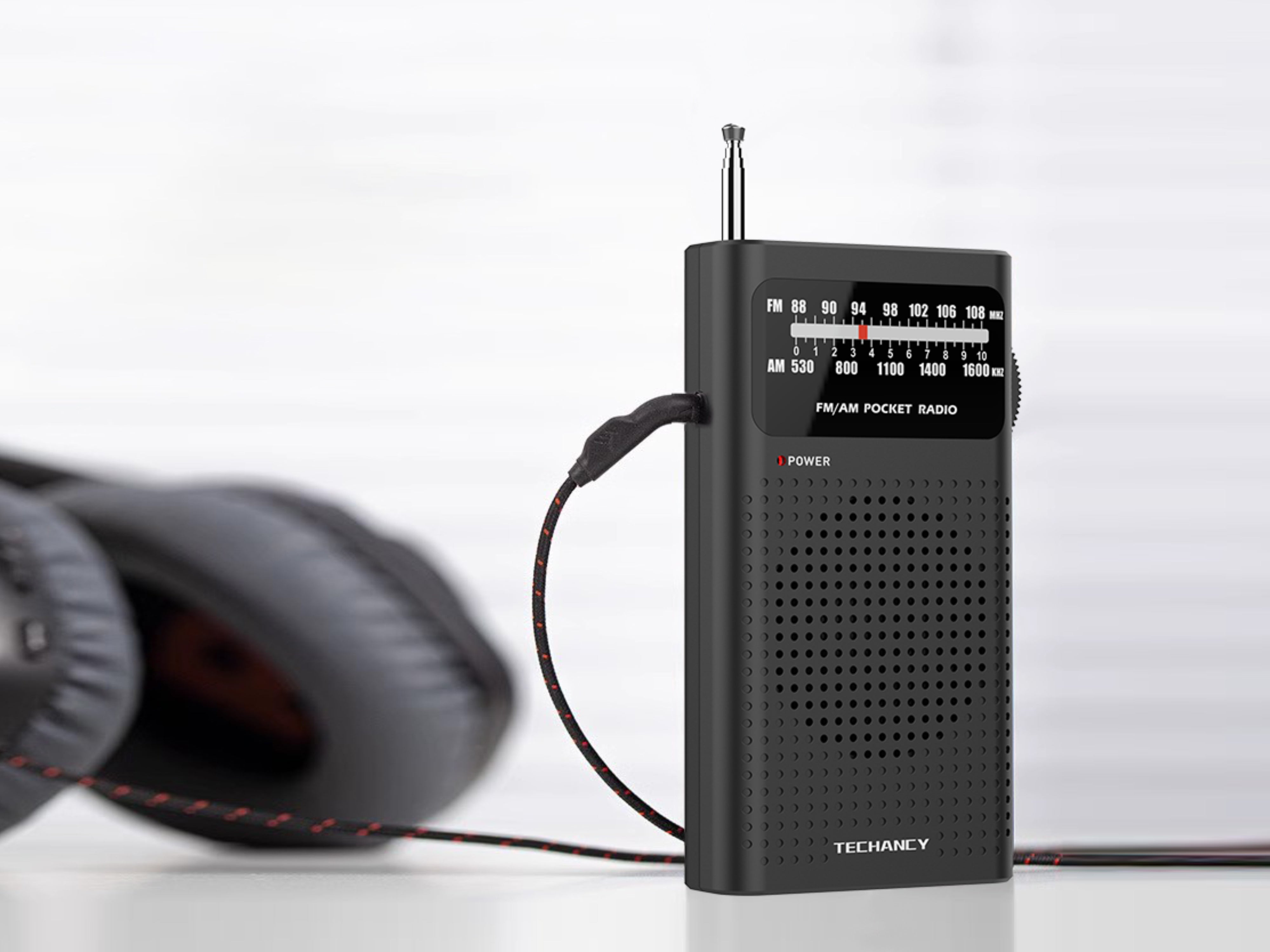 Techancy MJ2924 Portable FM/AM Radio with manual tuning, 3.5mm headphone jack, 2 AA batteries (not included), Black.